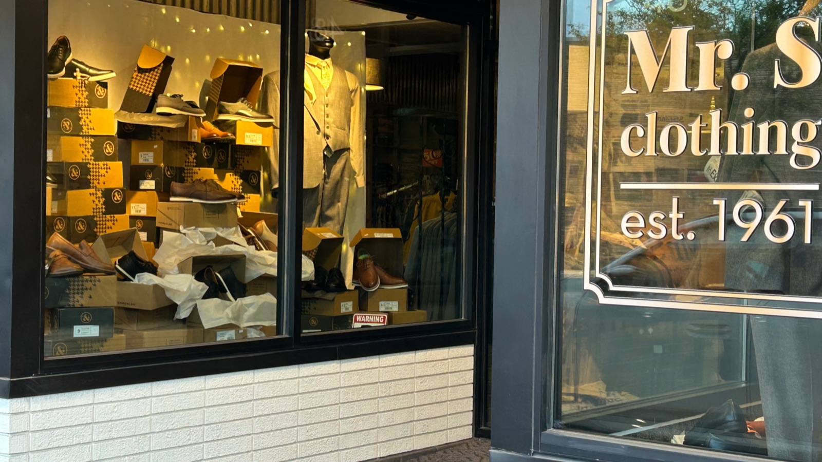 The Mr S Clothing storefront window in downtown Vernal, gold est. 1961 vinyl on the glass